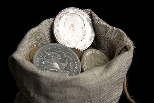 Five mark coin of German reich in sack bag isolated on black