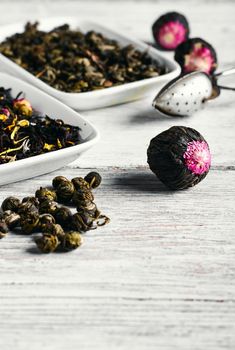 Set of different varieties of oriental tea on bright wooden background