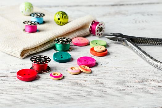 Beads,thread and bobbins for needlework.Picture in light key