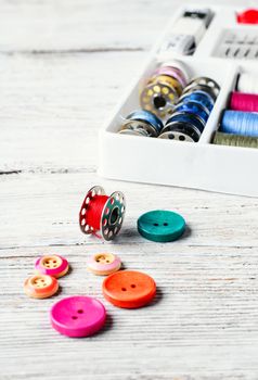 Beads,thread and bobbins for needlework.Picture in light key