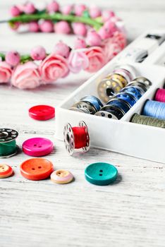 Beads,thread and bobbins for needlework.Picture in light key