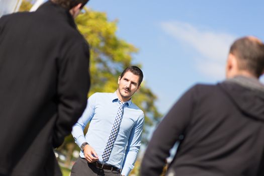 Businessman being approached and blackmailed by two racketeers.