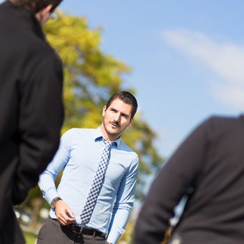 Businessman being approached and blackmailed by two racketeers.