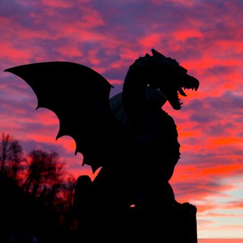 Vivid sunset sky over silhouette of Famous Dragon bridge, symbol of Ljubljana, capital of Slovenia, Europe.