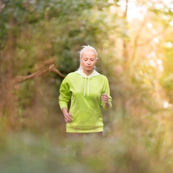 Pretty young girl runner in the forest.  Running woman. Female Runner Jogging during Outdoor Workout in a Nature. Beautiful fit Girl. Fitness model outdoors. Weight Loss. Healthy lifestyle. 