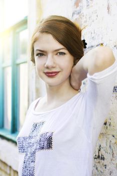 charming girl teen posing outdoors in bright sunlight