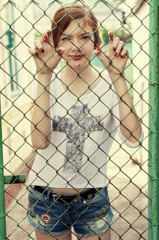 charming girl teen posing outdoors in bright sunlight