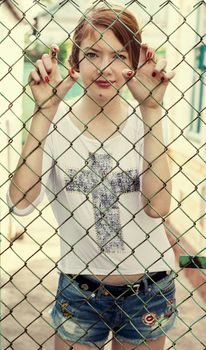 charming girl teen posing outdoors in bright sunlight