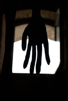 Black hand in front of the window isolated on white