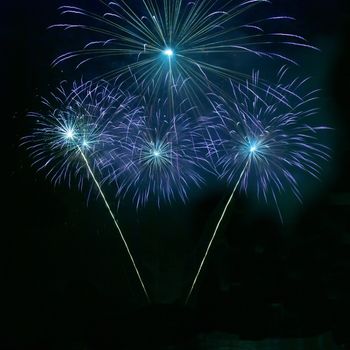 Blue fireworks on the black sky background