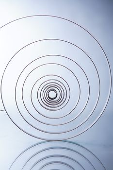 Industrial background. Closeup of old metal spiral on white background