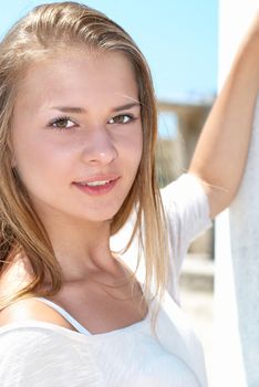 Beautiful blond girl outdoors against the sea