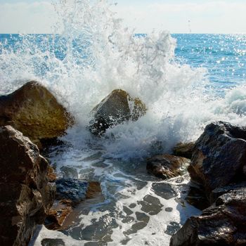 Sea, big wave and splash over the stones