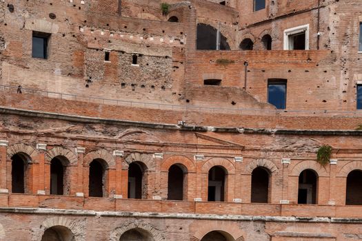 Close up detailed view of an ancient forum structure with orange bricks in Rome.