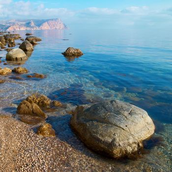 Sea, shore and stones. Seascape at sunset.