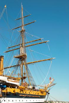 Beautiful sailing vessel with big masts on the mooring