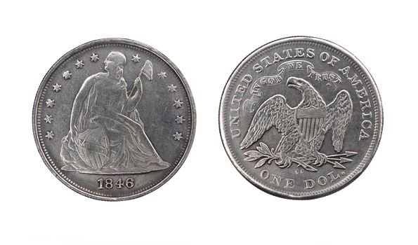 Two sides of old silver dollar of the USA isolated on white