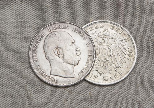 Old silver coins of German reich over sack