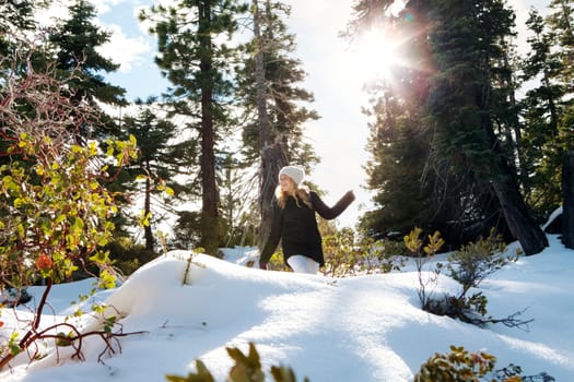 Portrait of young beautiful woman on winter outdoor background