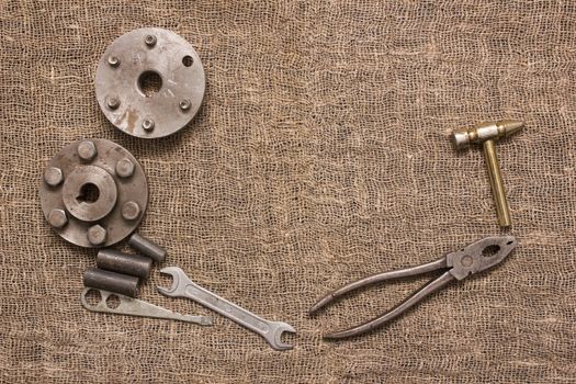 old rusty tools and details on the rough fabric. Instruments on sacking