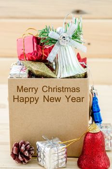 Christmas decoration in box with Merry Christmas and Happy New Year text on wooden background.