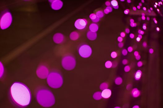 Bokeh of city lights in new year day with blurring pink lights.