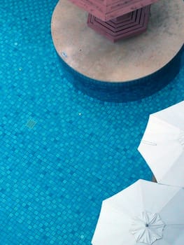 Top view of swimming pool side with umbrella