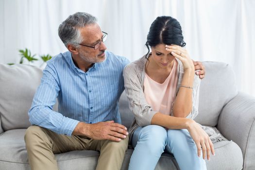 Therapist consoling a woman at home