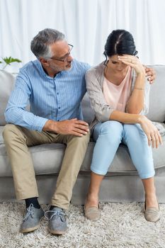 Therapist consoling a woman at home