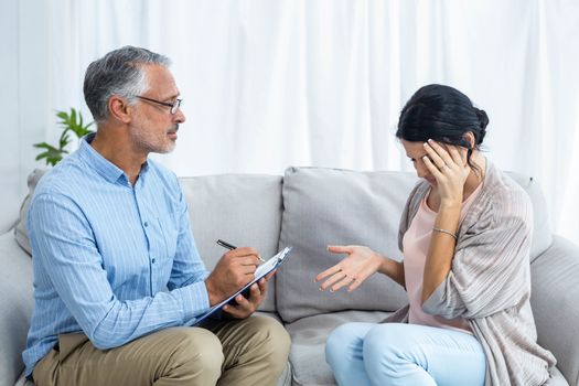 Therapist consoling a woman at home