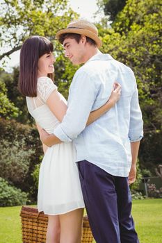 Young couple embracing each other in garden