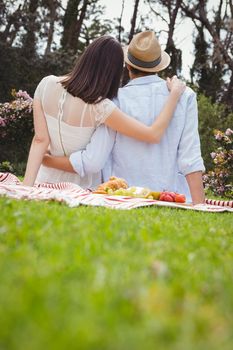 Rear view of young couple embracing each other in garden