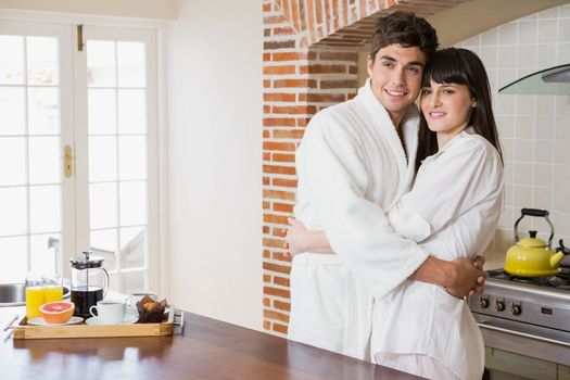 Romantic young couple embracing each other in kitchen