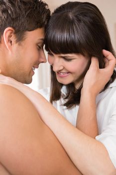 Romantic young couple embracing each other in kitchen