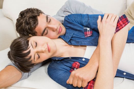 Romantic couple at home relaxing on the sofa in their living room