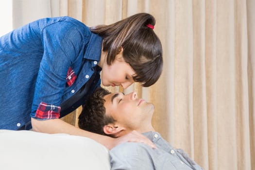 Romantic couple at home relaxing on the sofa in their living room