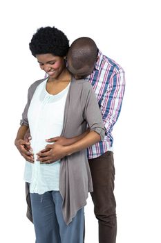 Pregnant couple smiling and embracing on white background