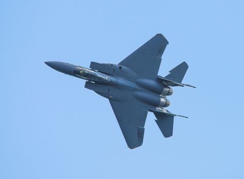 Singapore - February 16, 2016: Top view of McDonnell Douglas F‑15SG from Republic of Singapore Air Force during it’s performance at Singapore Airshow at Changi Exhibition Centre in Singapore.