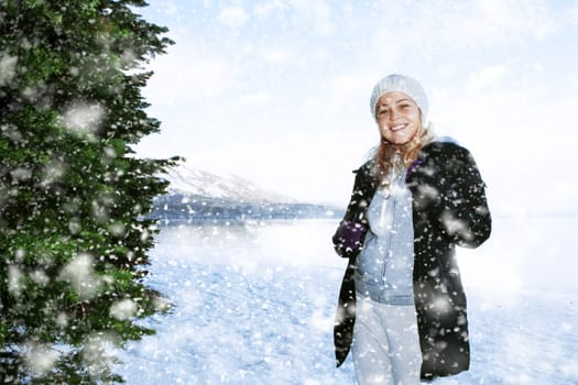 Portrait of young beautiful woman on winter outdoor background