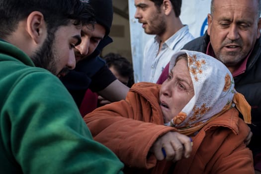 GREECE, Idomeni: A desperate woman cries as she tries to set herself on fire on March 1, 2016 in Idomeni to protest against Macedonia's decision to close its border. 