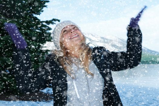 Portrait of young beautiful woman on winter outdoor background