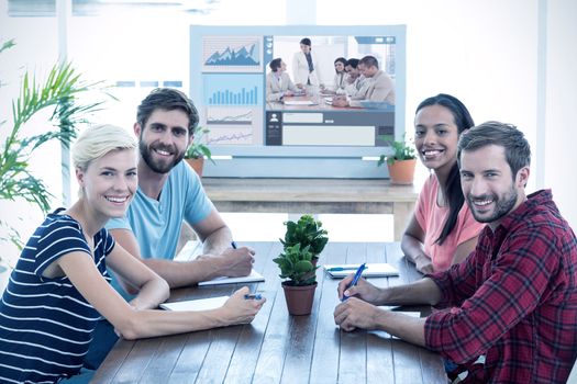 Friends sitting at a table against charismatic businesswoman doing a presentation