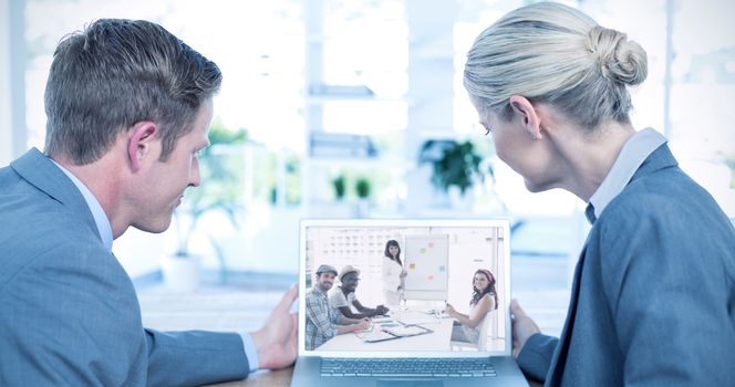 Business people looking at blank screen of laptop against smiling businessman and colleagues looking at camera