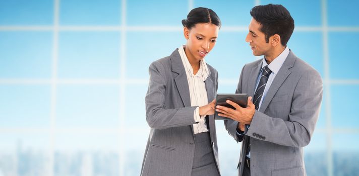 Business people discussing over digital tablet against view over city