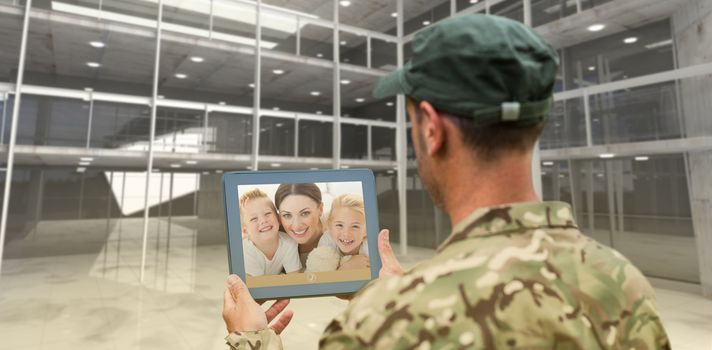 Soldier using tablet pc against inside a room
