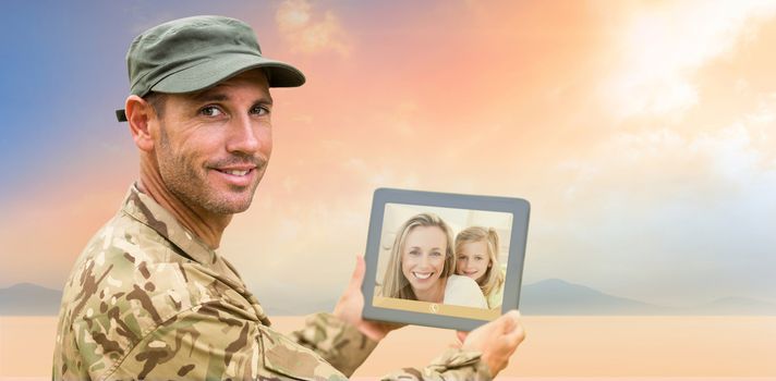 Soldier using tablet pc against desert landscape