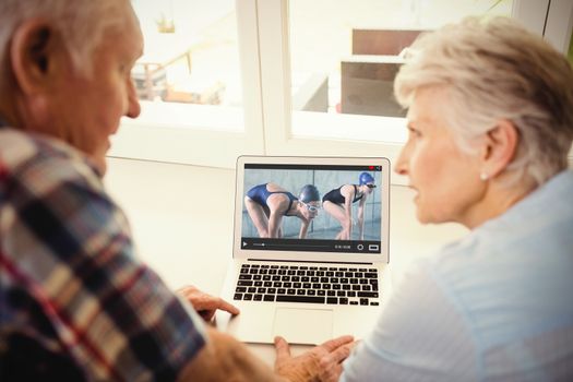 View of lecture app against senior couple using laptop