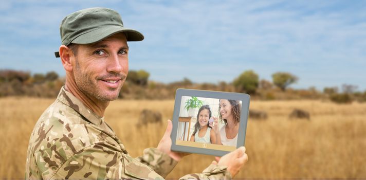 Soldier using tablet pc against landscape with animals