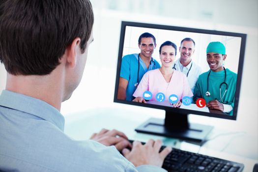 Portrait of a successful medical team at work against back view of a businessman working with a computer