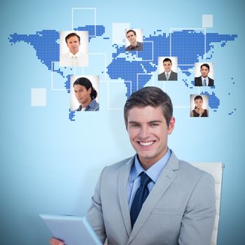 Portrait of smiling businessman using tablet computer against blue background